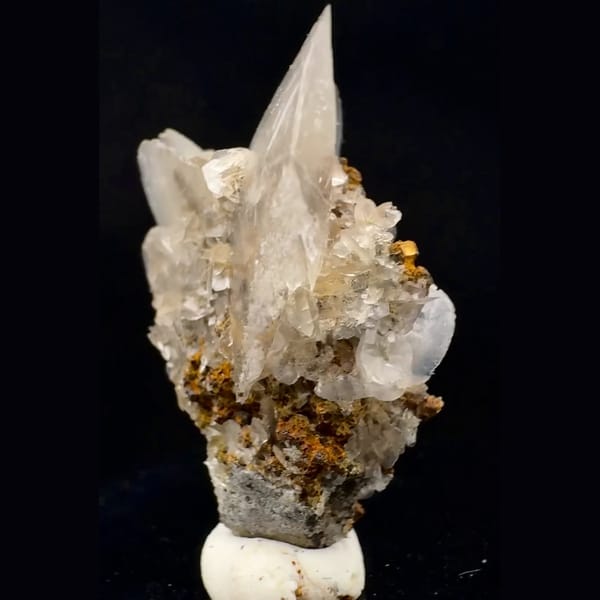 Translucent fan-shaped calcite blades on brown crystals from Fujian — alternate view