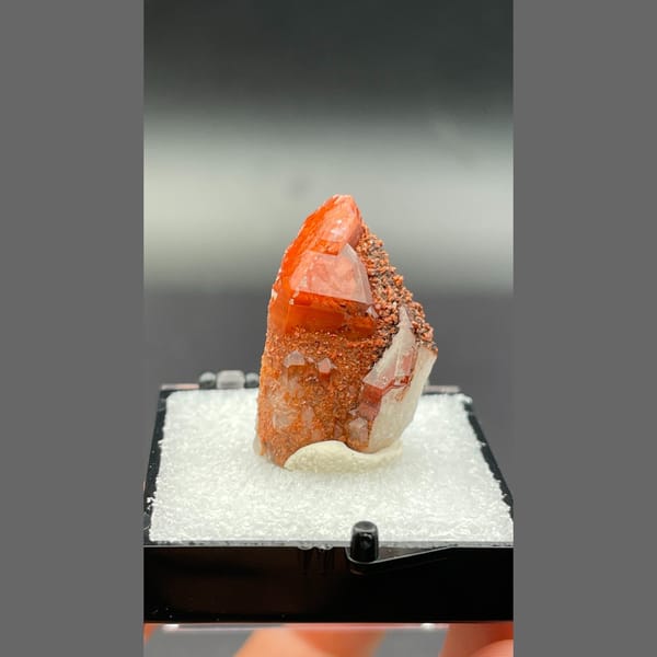 Red quartz point with dark specks from Shanxi — complete view