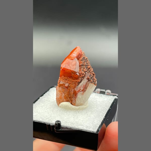 Red quartz point with dark specks from Shanxi — alternate view