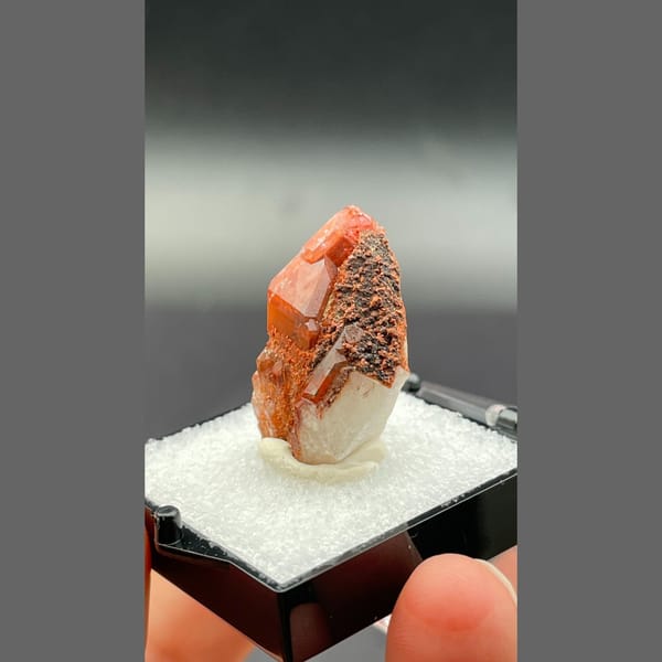 Red quartz point with dark specks from Shanxi — alternate view