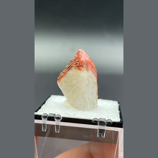 Red quartz point with dark specks from Shanxi — detail view