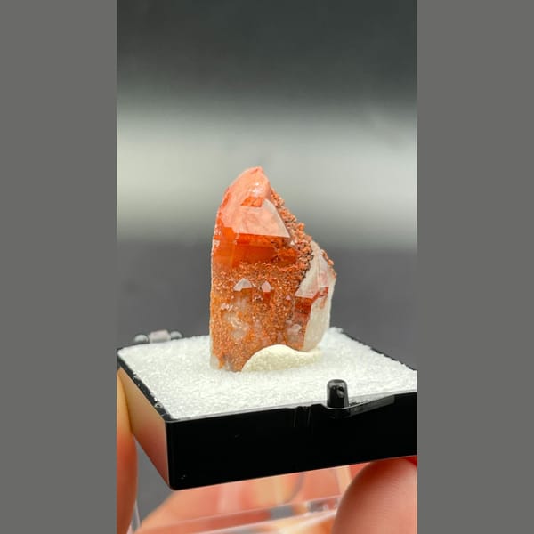 Red quartz point with dark specks from Shanxi — detail view