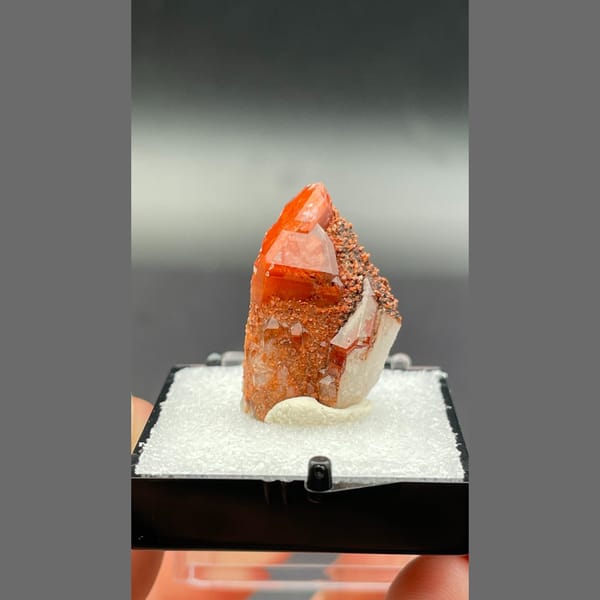 Red quartz point with dark specks from Shanxi — detail view