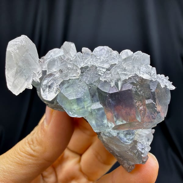 Star-twinned calcite with purple-cored green fluorite and pyrite from Fujian — complete view