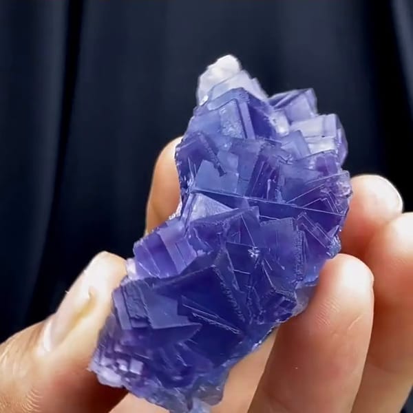 Complete reverse source-video view of the exact violet-blue fluorite specimen