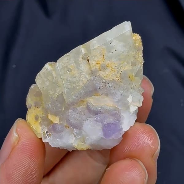 Complete rotated source-video view of purple fluorite with pale crystals