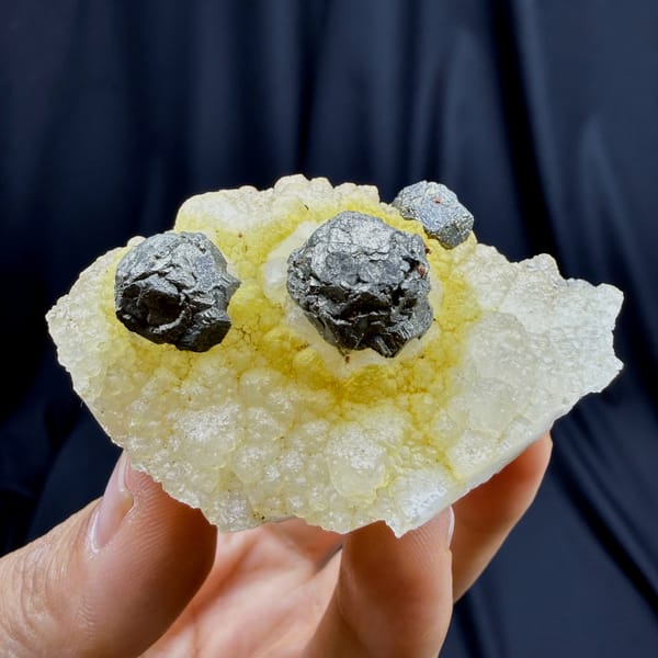 Dark spherical pyrite balls on yellow quartz from Jiangxi — complete view