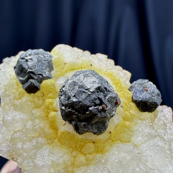 Dark spherical pyrite balls on yellow quartz from Jiangxi — alternate view