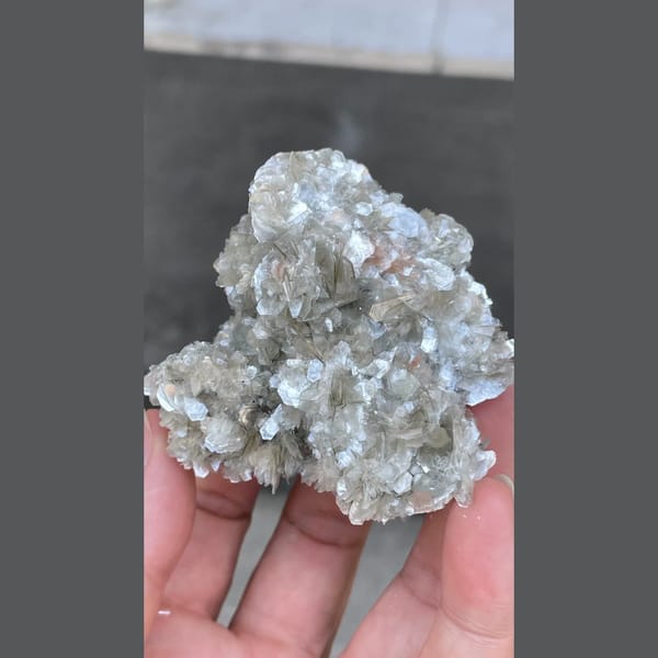 Glittering silvery mica flower cluster from Xuebaoding, Sichuan — complete view