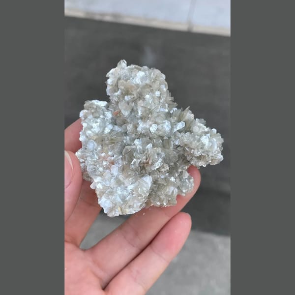 Glittering silvery mica flower cluster from Xuebaoding, Sichuan — detail view