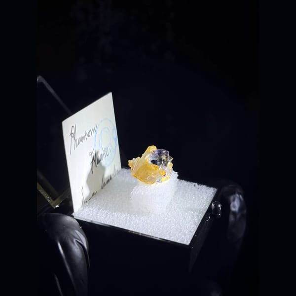Phantom fluorite with iridescent quartz from Yindu in a specimen box — alternate view