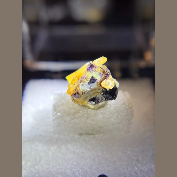 Phantom fluorite with iridescent quartz from Yindu in a specimen box — detail view