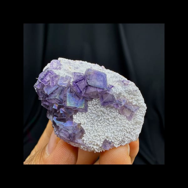 Complete front view of iridescent purple fluorite with quartz