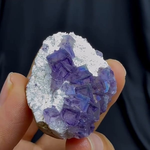 Complete rotated source-video view of purple fluorite with quartz