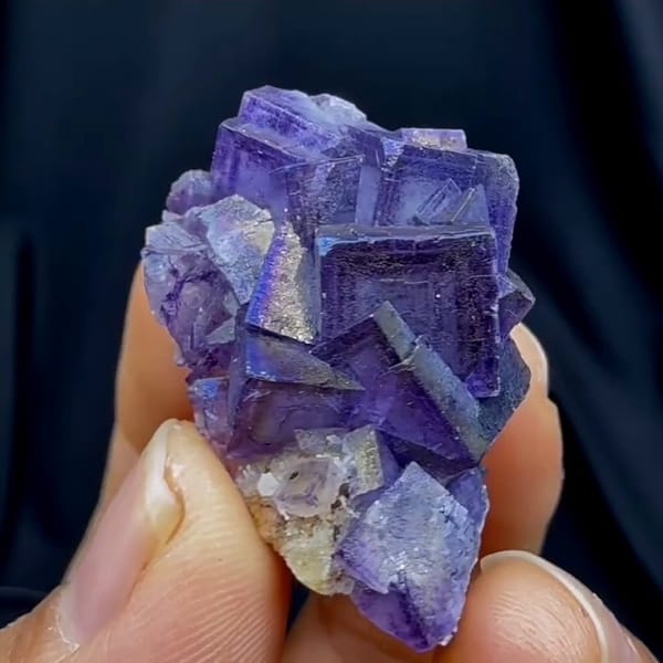 Complete reverse source-video view of the exact purple fluorite specimen