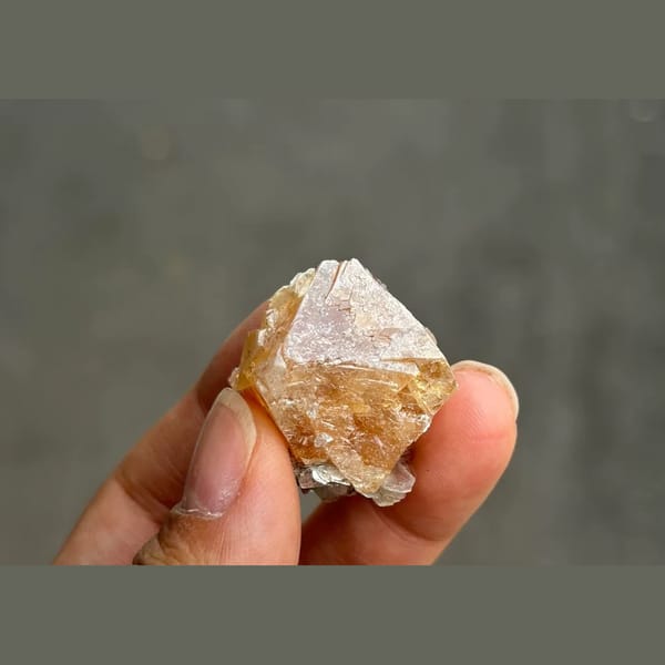 Orange scheelite octahedron with silvery mica from Xuebaoding — detail view