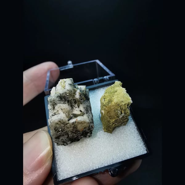 Two feldspar specimens with black tourmaline and epidote — alternate view