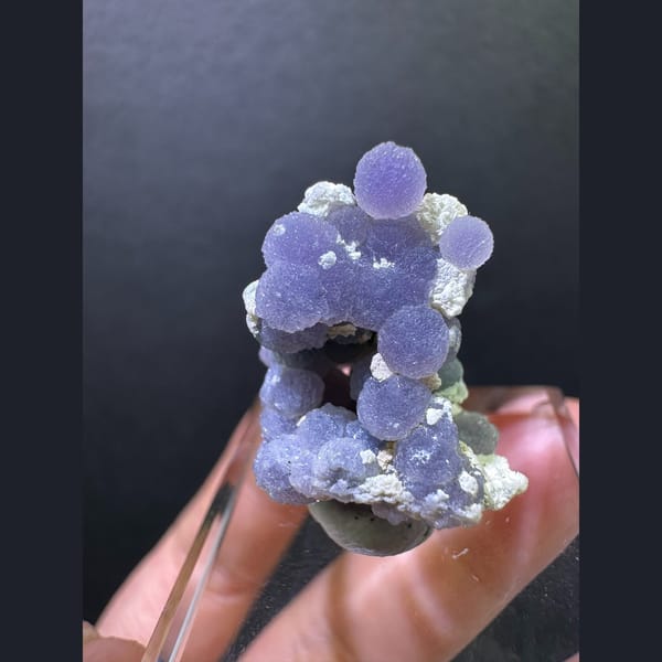 Purple grape agate spheres on matrix — alternate view