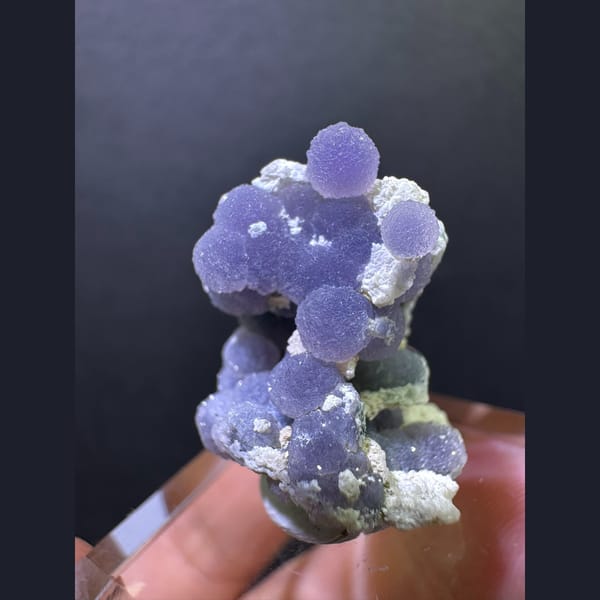 Purple grape agate spheres on matrix — alternate view