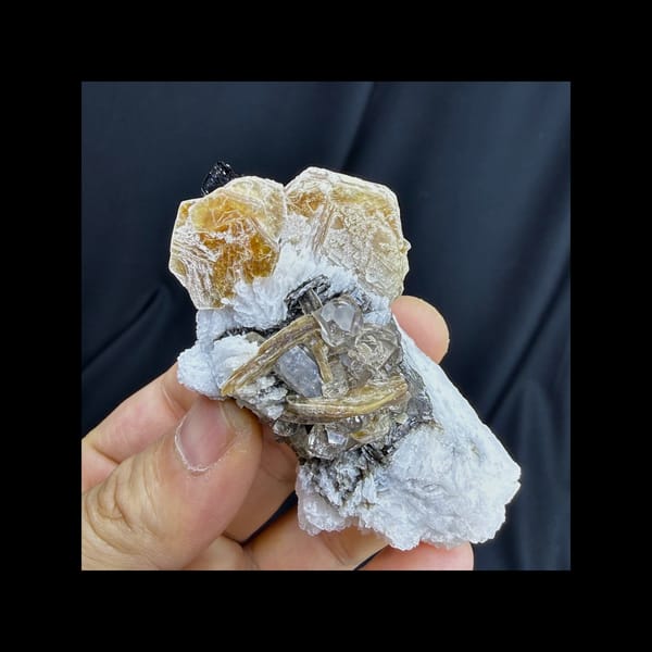 Complete front view of topaz with tourmaline feldspar and mica