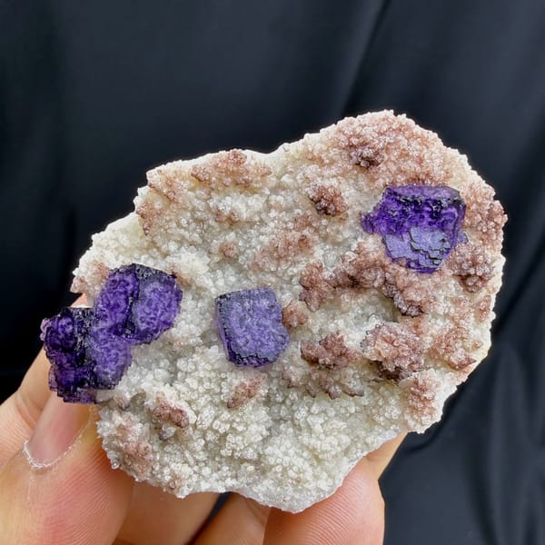 Complete reverse face of purple fluorite on pale quartz