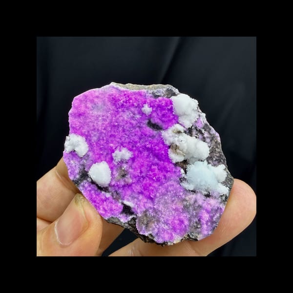 Complete face view of purple-red and white aragonite growth