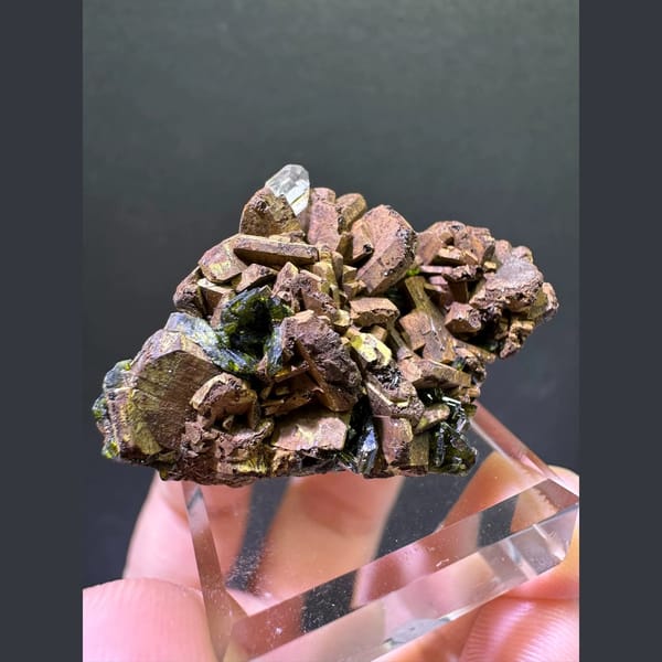 Bronze epidote crystal cluster with small quartz point from Sichuan — complete view