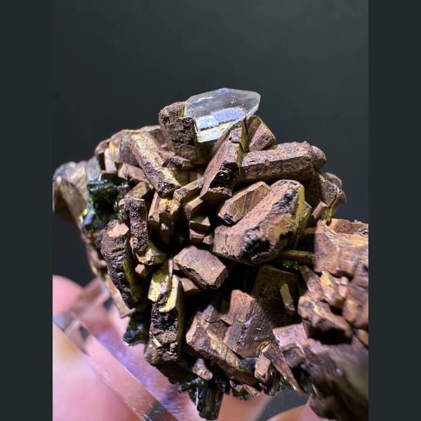Bronze epidote crystal cluster with small quartz point from Sichuan — detail view