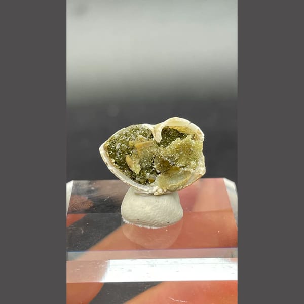 Small olive-green anapaite crystal ball from Yunnan — detail view