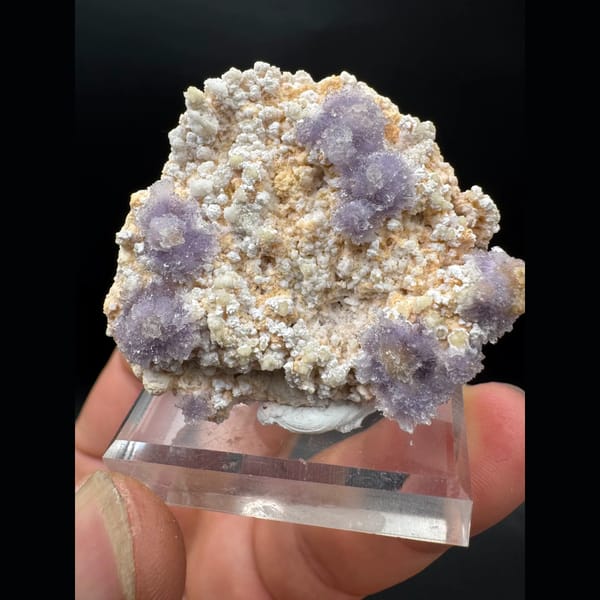 Purple creedite flower clusters on matrix from Guizhou — detail view