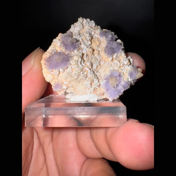 Purple creedite flower clusters on matrix from Guizhou — detail view
