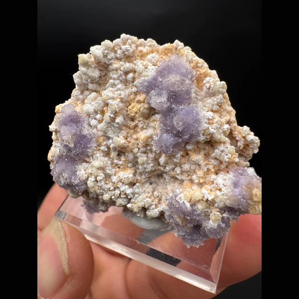 Purple creedite flower clusters on matrix from Guizhou — detail view
