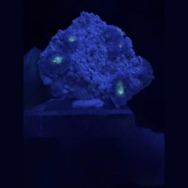 Purple creedite flower clusters on matrix from Guizhou — detail view