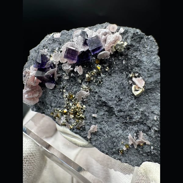 Purple-blue cubic fluorite with pyrite and rhodochrosite — detail view