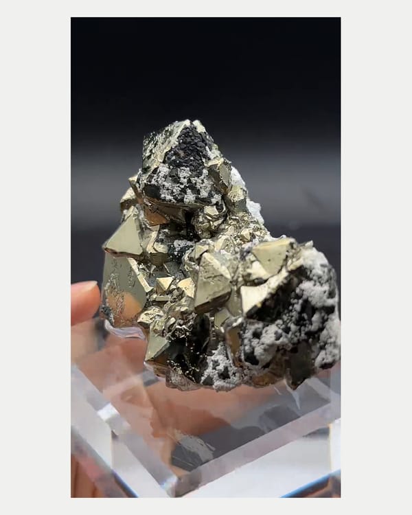 Complete left oblique view of pyrite with marmatite and calcite