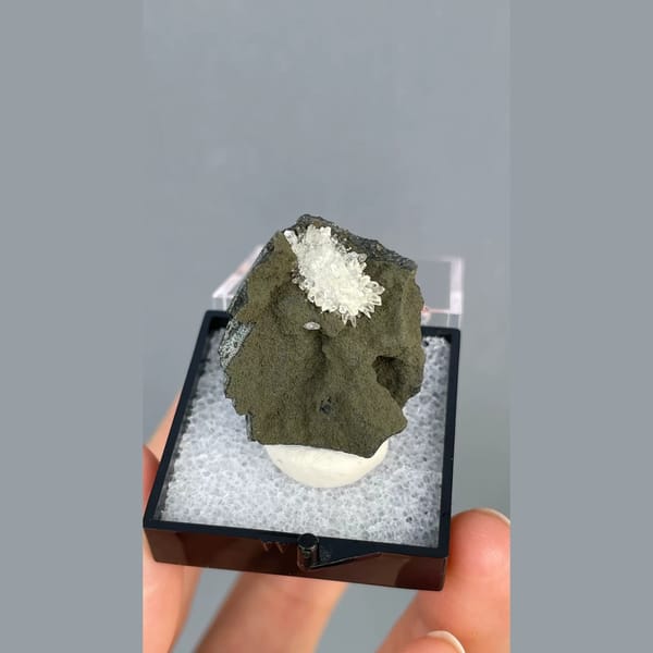 White calcite crystals on dark matrix from Vietnam — alternate view
