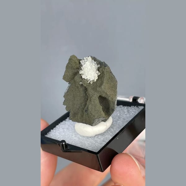 White calcite crystals on dark matrix from Vietnam — detail view