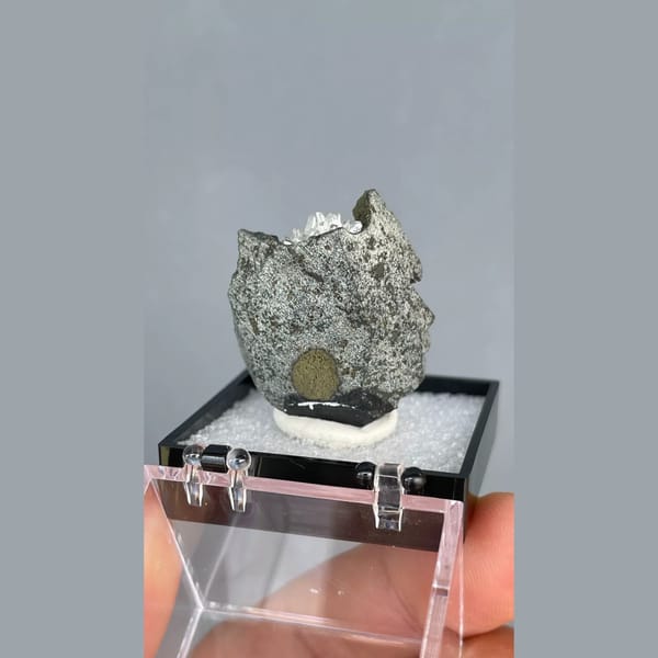 White calcite crystals on dark matrix from Vietnam — detail view