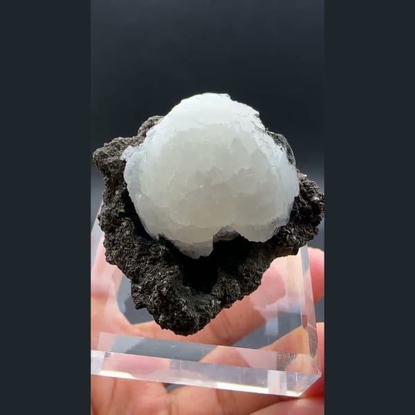 White stilbite ball on dark basalt from Aurangabad, India — alternate view