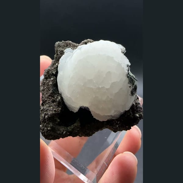 White stilbite ball on dark basalt from Aurangabad, India — alternate view