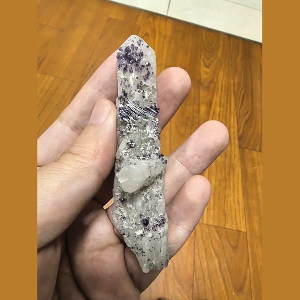 Purple beaded fluorite on slender white quartz crystal — alternate view