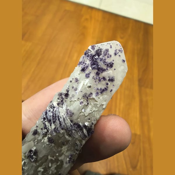 Purple beaded fluorite on slender white quartz crystal — alternate view