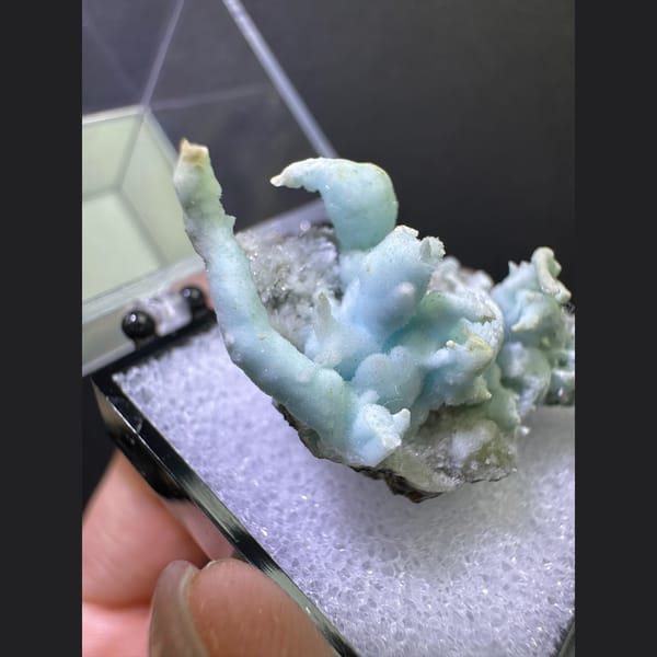 Pale blue coral-like aragonite on matrix from Yunnan — detail view