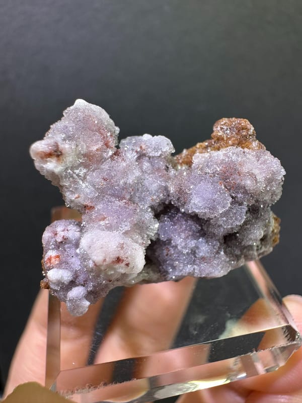 Second complete angle of rounded violet creedite on matrix