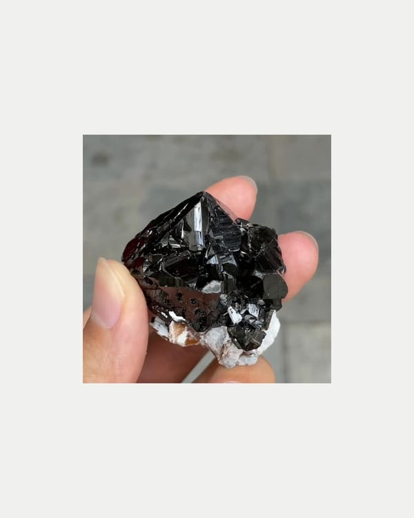 Complete left oblique view of lustrous cassiterite with mica