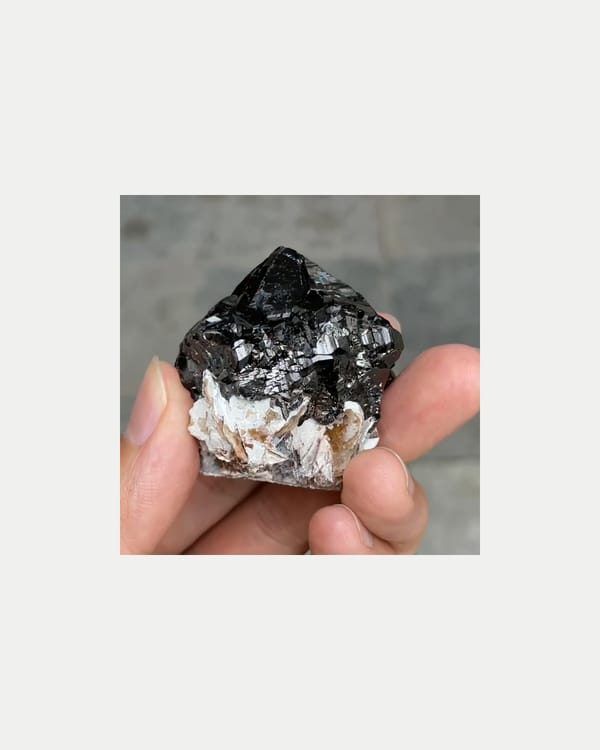 Complete reverse view of lustrous cassiterite with mica
