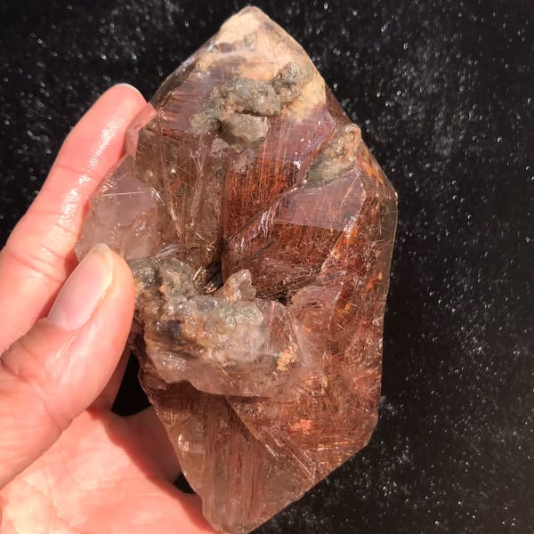 Quartz crystal densely packed with red-copper rutile needles — alternate view