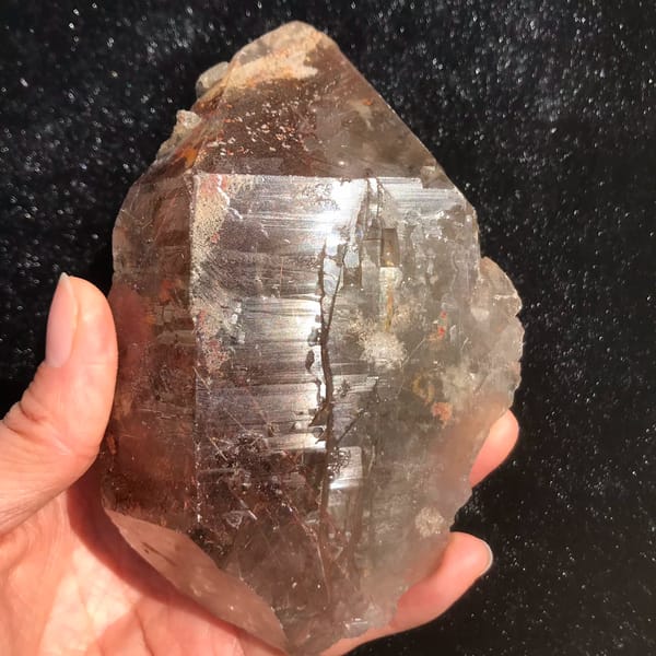 Quartz crystal densely packed with red-copper rutile needles — alternate view