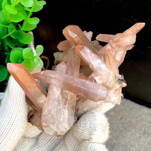 Spiky cluster of red-pink hematoid quartz points — detail view