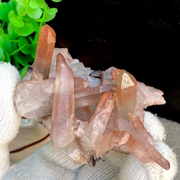Spiky cluster of red-pink hematoid quartz points — detail view